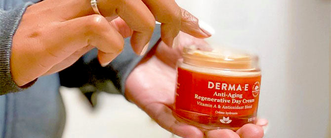 Woman applying Derma E anti-aging moisturizer